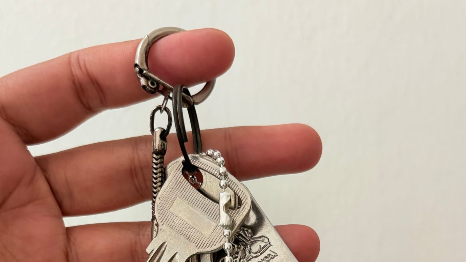 Mint extension plug keychain hanging from a set of keys